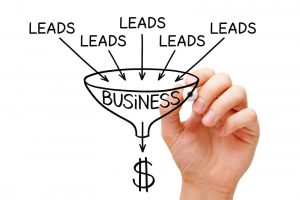 Sketch of the word “leads” written several times, all pouring into a sales funnel and converting into cash.